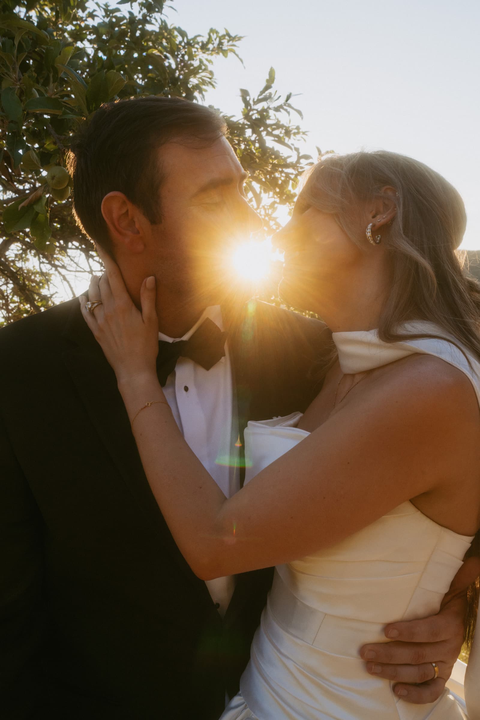 Bride and groom kissing at golden hour in Italy