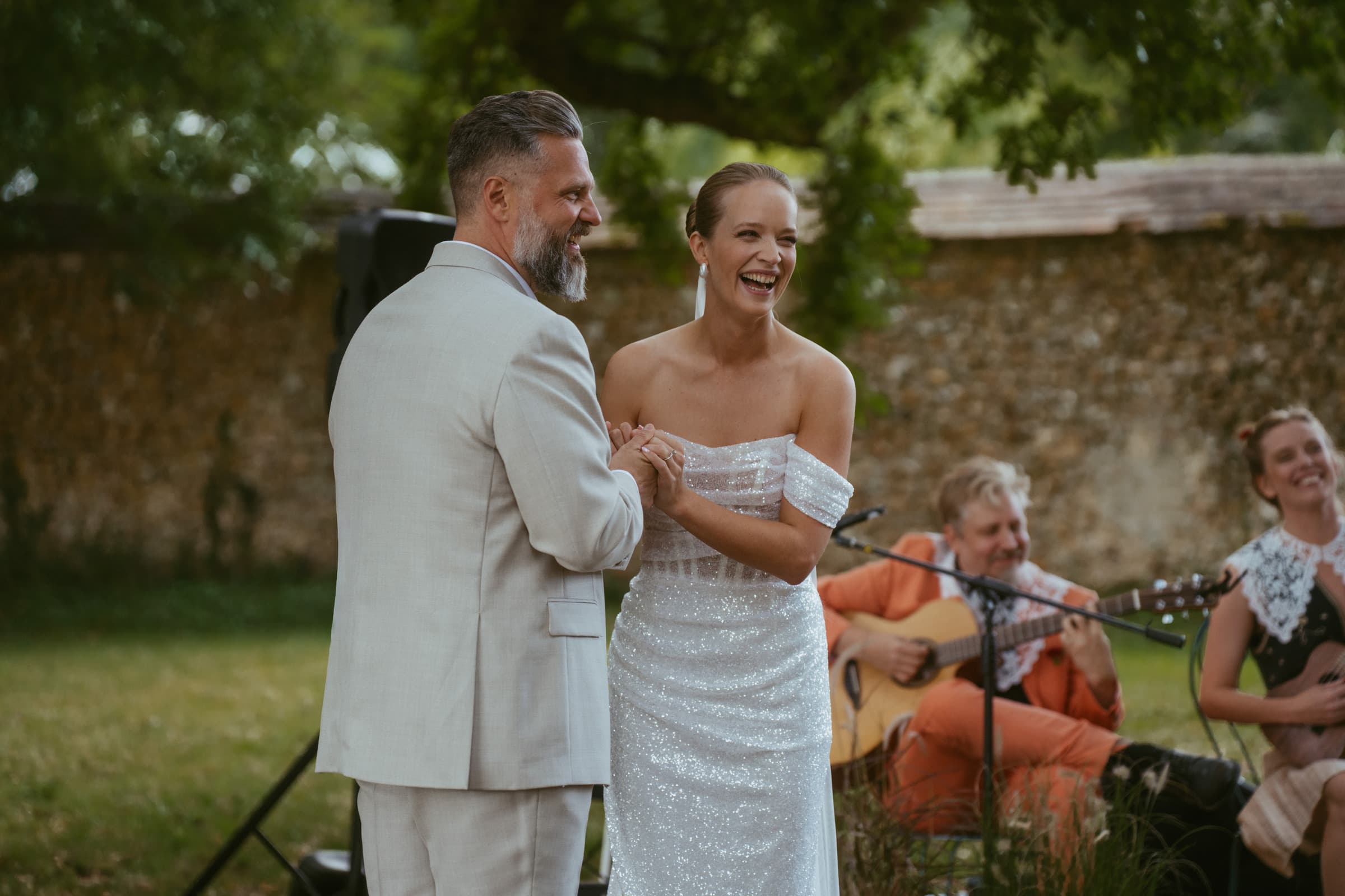 Bride and groom laughing at their wedding ceremony, France