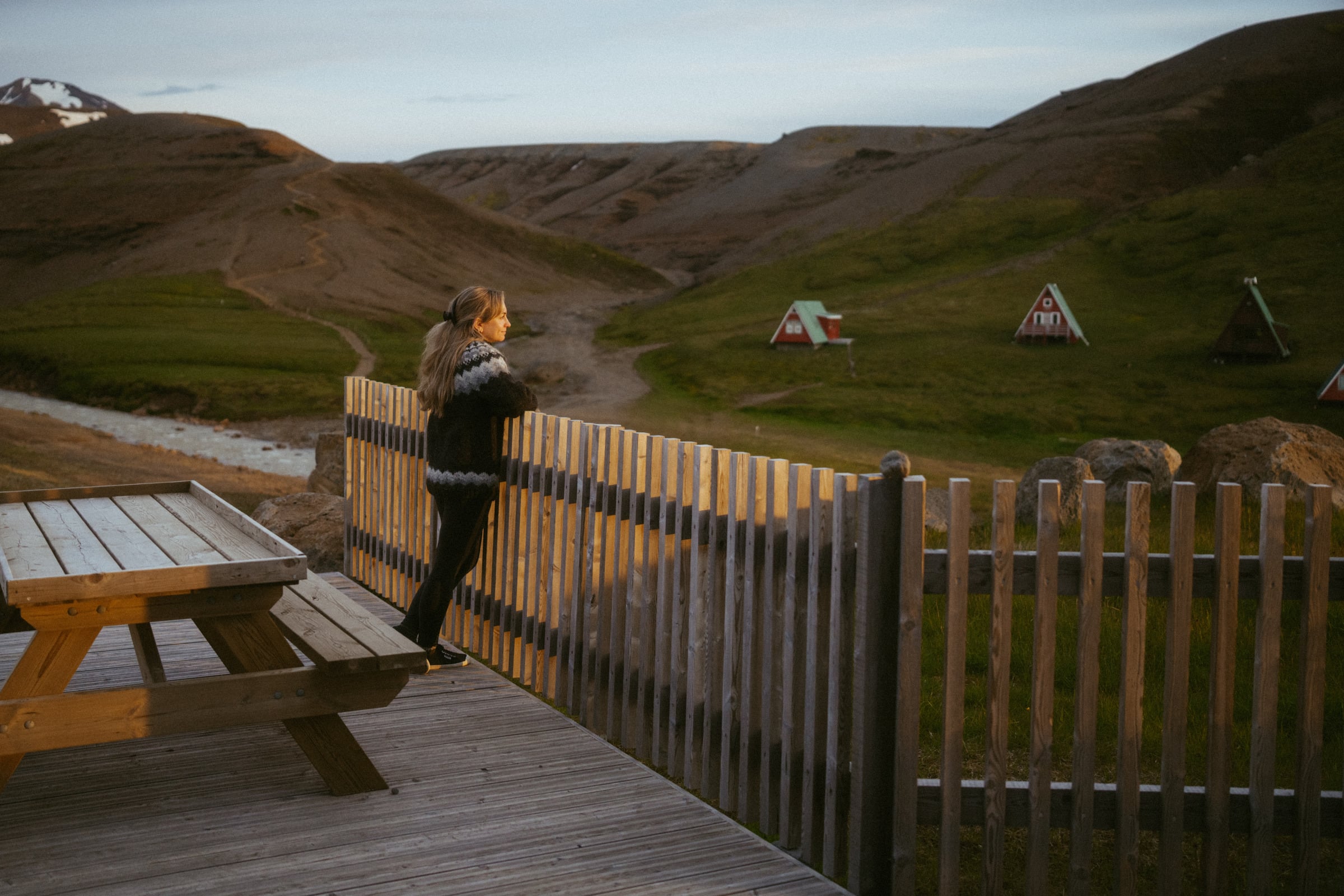 Caroline at a highland cabin in Iceland, looking out over the valley