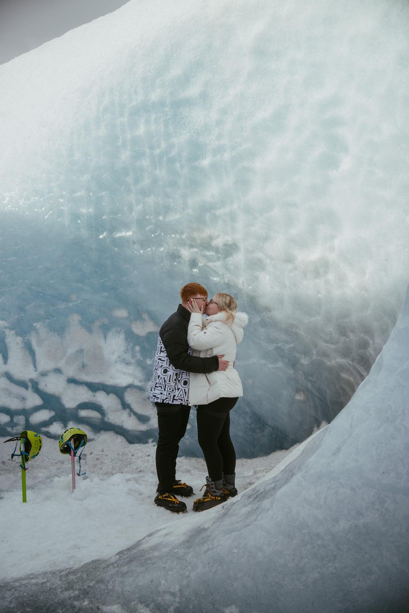 Couple inside a blue glacier ice cave in Iceland