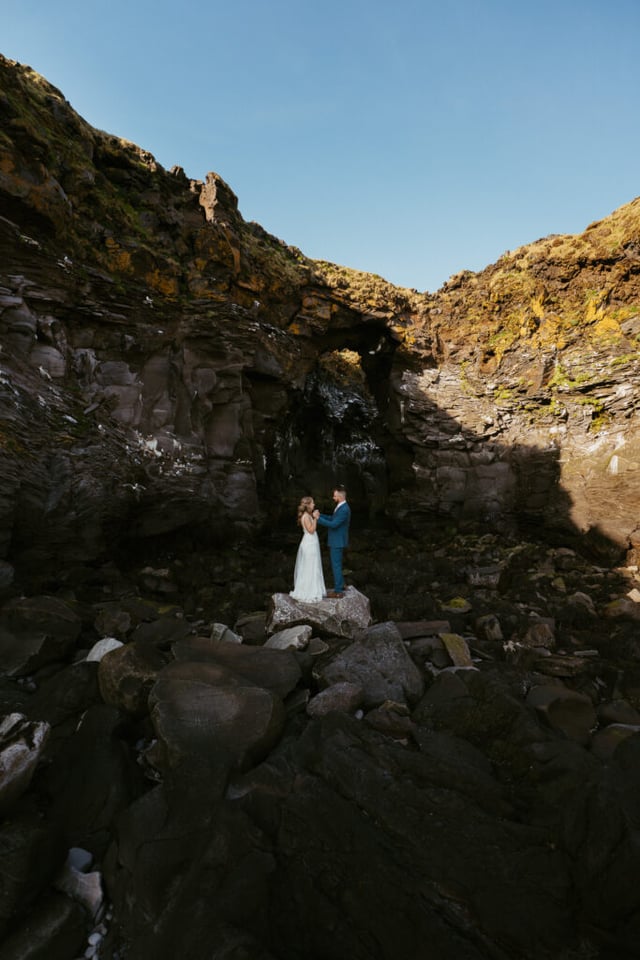 Wide landscape wedding photo near Hellnar coastline in Snæfellsnes
