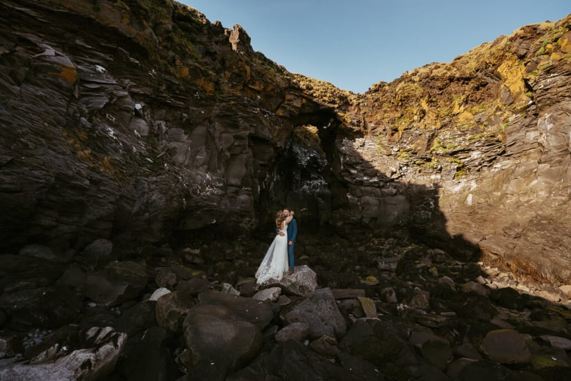 Wide landscape wedding photo near Hellnar coastline in Snæfellsnes
