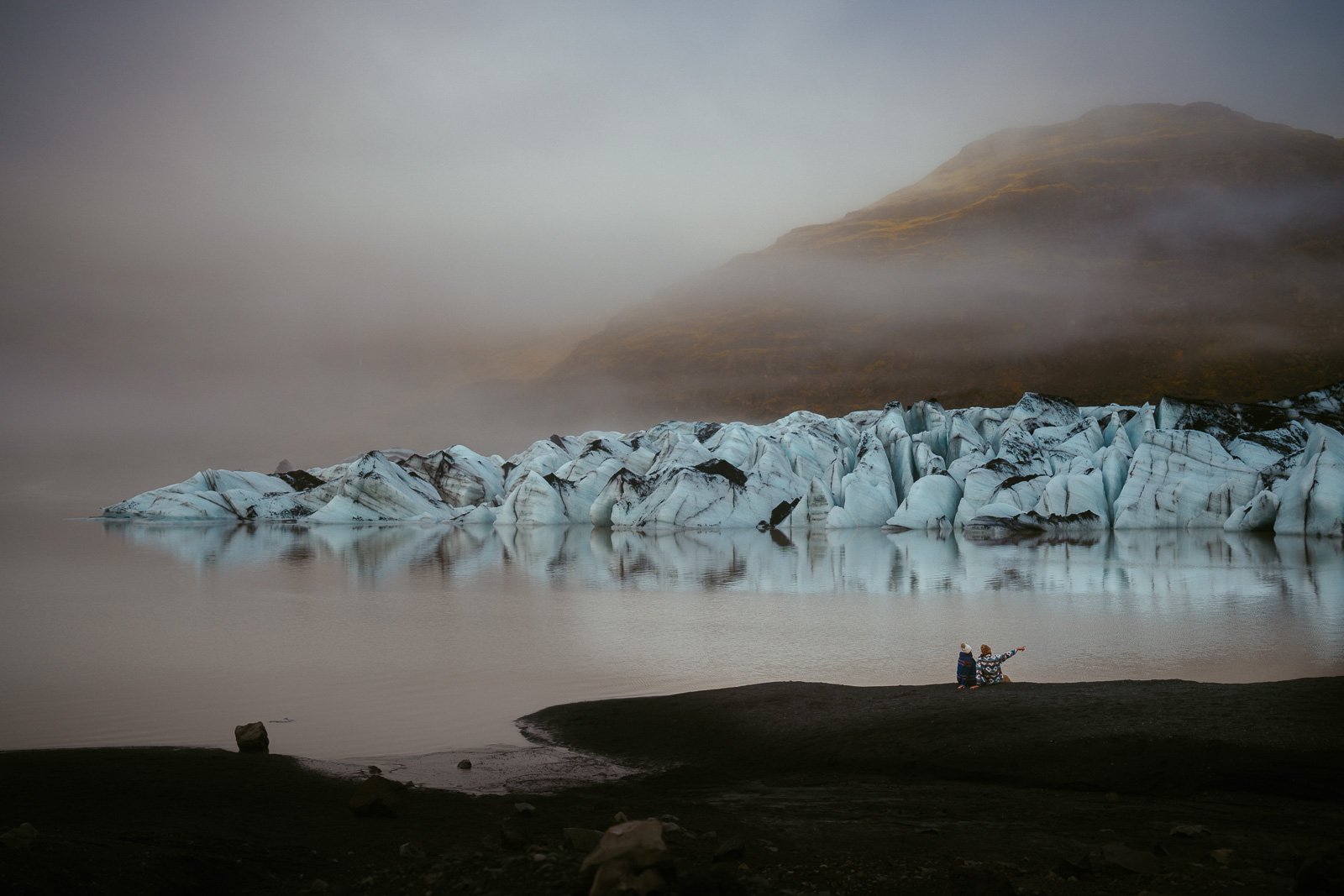 Surprise proposal in front of an Iceland waterfall
