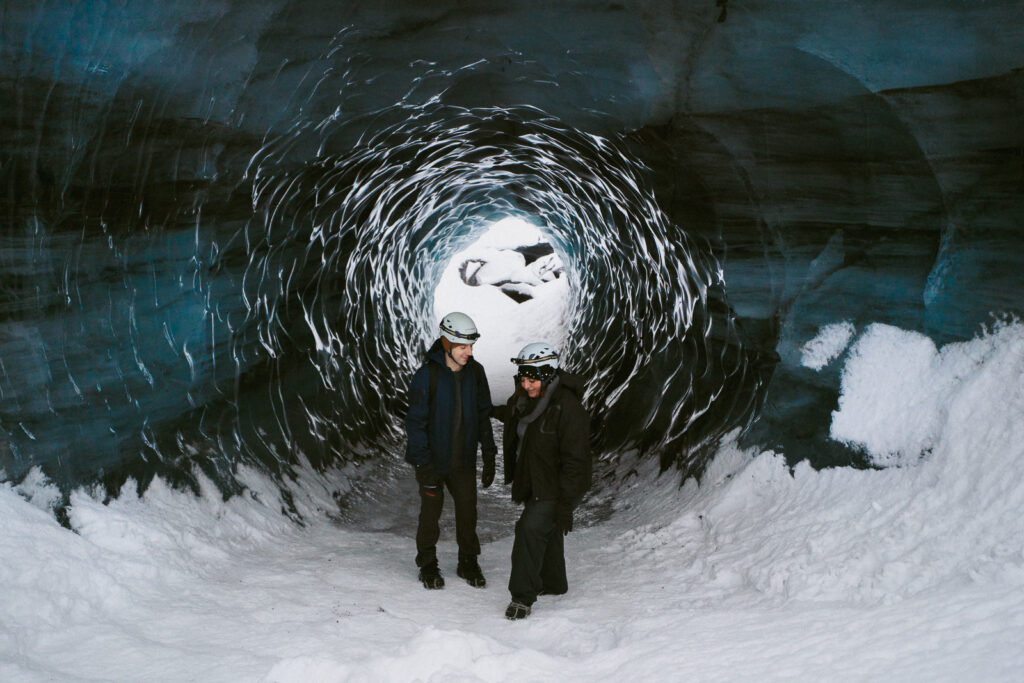 Engaged couple smiling in the ice cave after saying yes