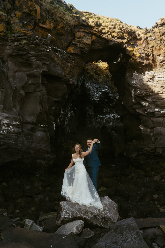 Wide landscape wedding photo near Hellnar coastline in Snæfellsnes