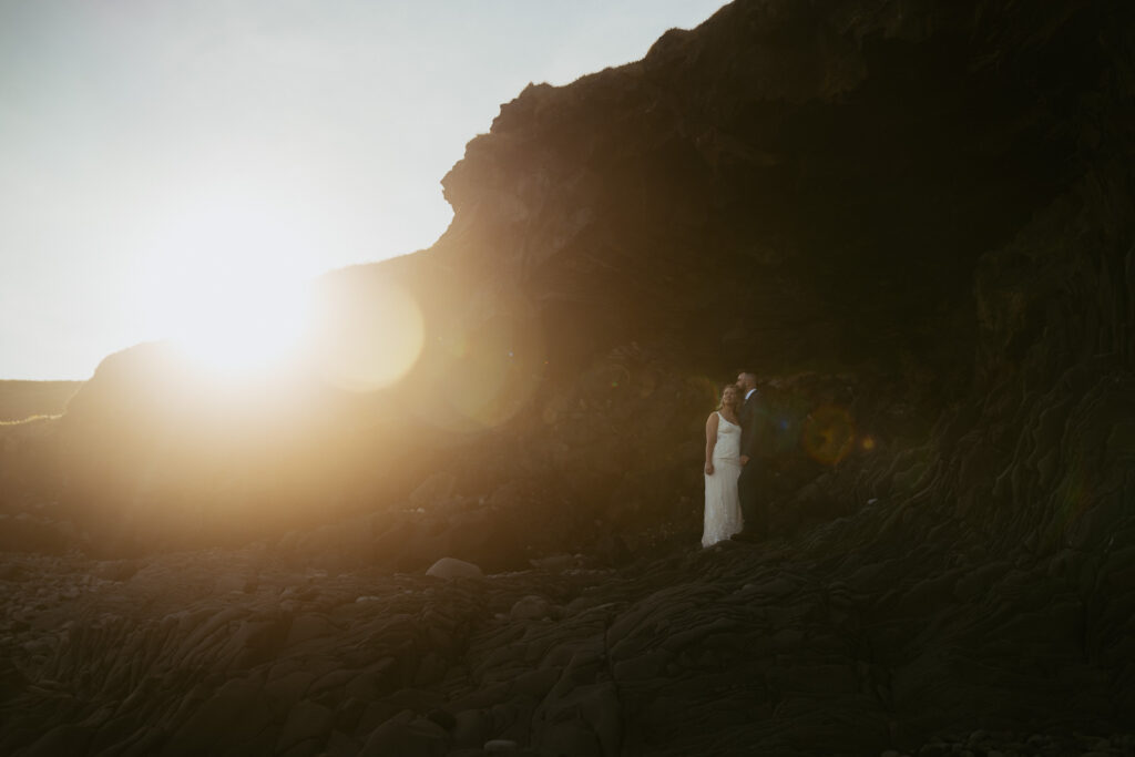 Wide landscape wedding photo near Hellnar coastline in Snæfellsnes