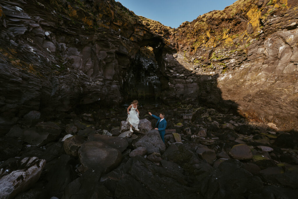 Wide landscape wedding photo near Hellnar coastline in Snæfellsnes