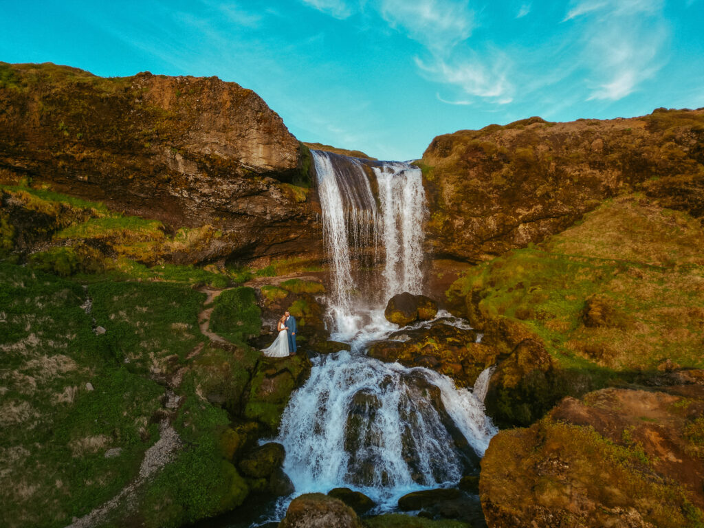 Romantic wedding photo at Selvallafoss waterfall in West Iceland