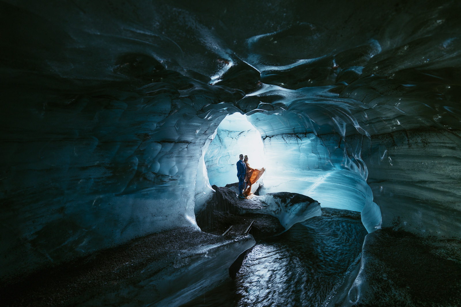 couple standing in an ice cave in iceland while eloping