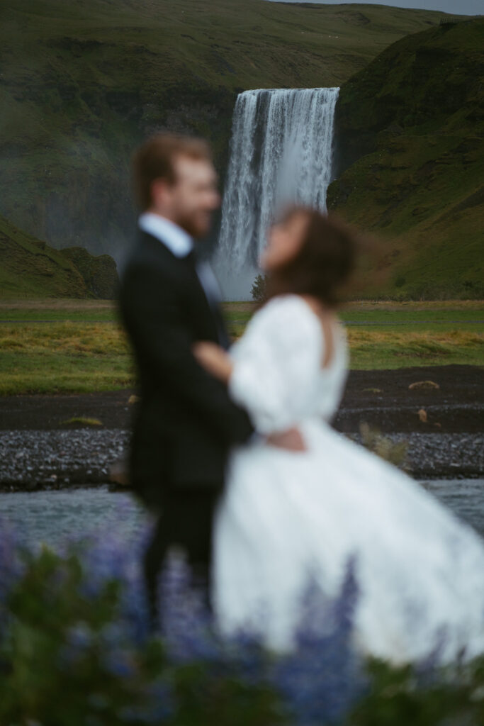 couple eloping in front of skogafoss